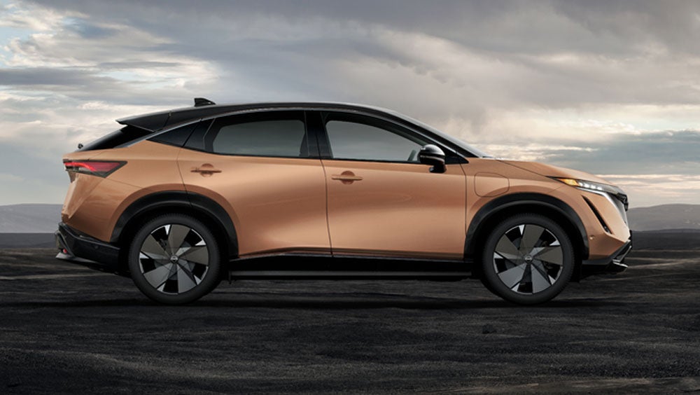 Nissan ARIYA in Sunrise Copper in dramatic landscape | Fort Collins Nissan in Fort Collins CO